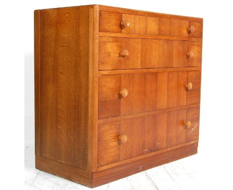 A mid century light oak chest of drawers / secretaire by Kandya. The chest having four graduated drawers with knob handles ra