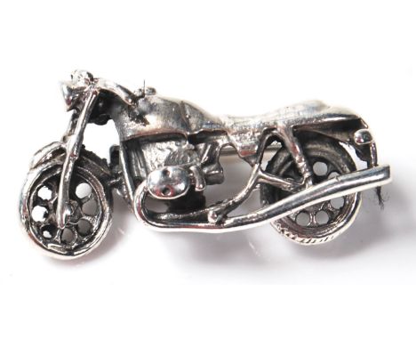 A stamped 925 silver brooch pin in the form of a Harley Davidson chopper motorbike. Measures 34mm in length. Weighs 9.69 gram