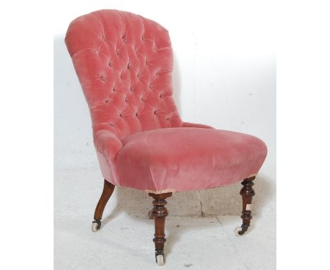 A 19th Century Victorian button back nursing chair / bedroom chair being upholstered in pink velvet having a shaped back. All