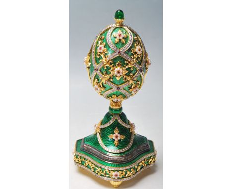 An original Franklin Mint House of Faberge Presents 'The Garden of Jewels Imperial egg ' Imperial musical egg, gold plated, s