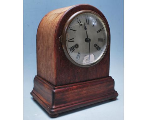 An early 20th century / Edwardian mahogany dome top mantel clock having silver dial with Roman numerals to the chapter, plint