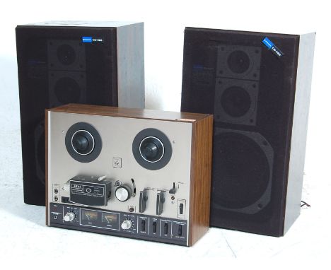 A retro 1970's vintage AKAI 4000DS reel to reel tape recorder player - One Micron Gap&nbsp; Head - Three Head in faux wood su