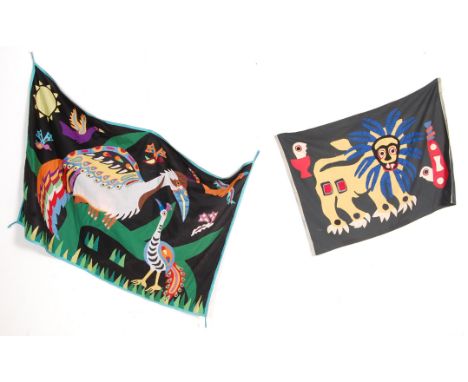 A collection of two vintage 20th century tribal flags to include a smaller African tribal flag depicting a lion and a New Zea