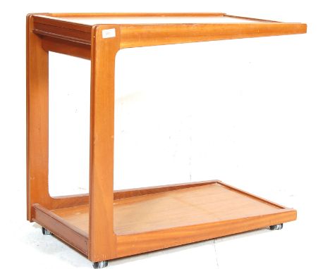 A vintage 1970’s Danish influence teak wood butlers serving trolley having a floating top shelf with gallery border attached 