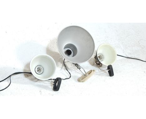 A collection of three vintage 20th century Industrial type clamp desk / worktop lights to include two black shades lamps with