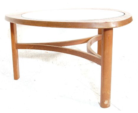 A vintage 1970’s teak wood and glass coffee table having an unusual triangle shaped top with circular glass raised on three s