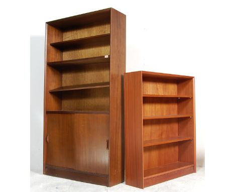 A pair of mid century Gibbs bookcases. One small light oak with sliding glass doors and adjustable shelves along with a tall 