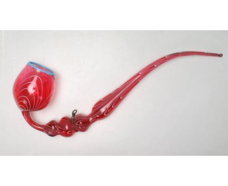 A large 19th century Victorian Nailsea cranberry glass pipe with white enamel paint decoration to the body and blue enamel ri