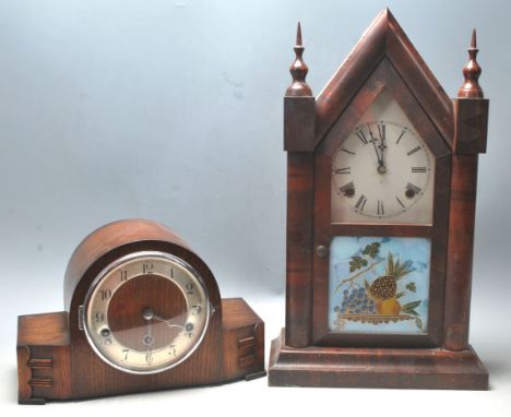 A Victorian 19th century walnut gingerbread clock in spire shaped case having painted glass panel with fruit bowl of pineappl