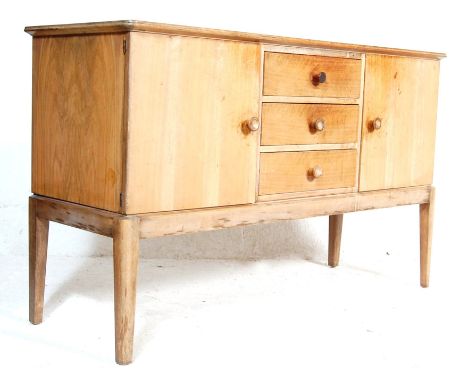 An original mid 20th Century vintage Gordon Russell walnut sideboard / dresser. Raised on squared legs with a chest of three 