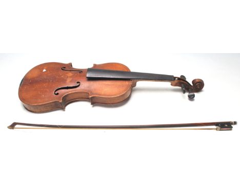 An early 20th Century / late 19th Century antique violin musical instrument having a hollow body with pierces S shaped sound 