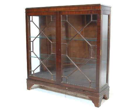 An antique style Regency mahogany china vitrine display cabinet. Raised on bracket feet with twin full length astragal glazed