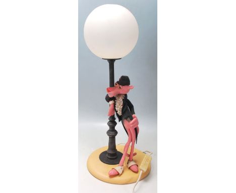 A vintage retro novelty desk / table lamp in the form of pink panther in a suit standing beneath a street lamp with bulbous b