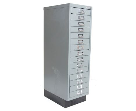 A retro vintage 20th century industrial factory metal upright chest of drawers. The chest having a bank of 15 drawers each wi
