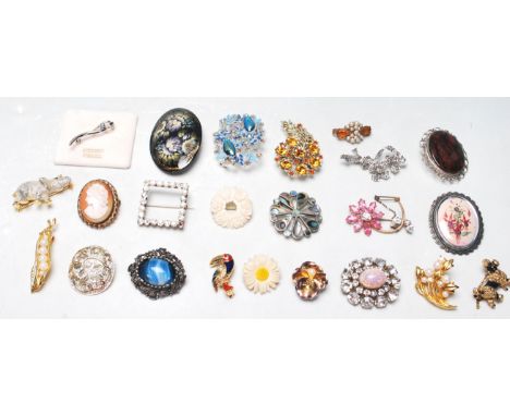 A collection of 23 vintage lady’s pin brooches to include cameo brooch, dogs broches, elephant brooch, yellow metal and faux 