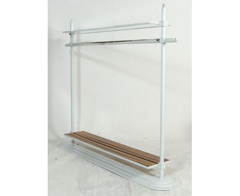 A stunning vintage Art Deco style metal haberdashery shop floor standing clothes rail having pointed finials, glass top, shel