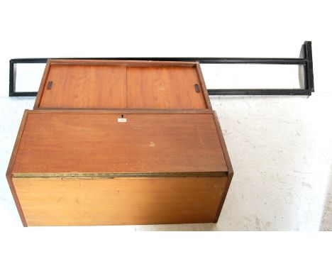 A vintage mid century teak wood veneer modular unite in the manner of ladderax comprising of two adjustable cabinets on squar