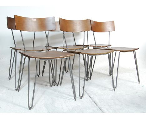 A set of six vintage 20th century chairs having plywood backrests and seats with grey painted metal tubular brave raised on h