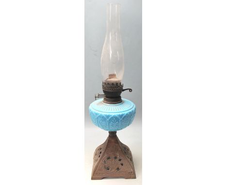 A Victorian 19th century cast iron and blue glass oil lamp. The pierced cast iron base with blue glass central reservoir comp