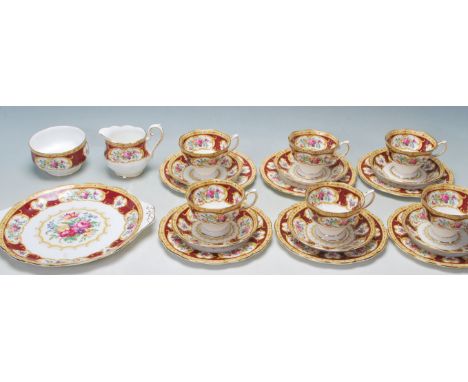 A Royal Albert - Lady Hamilton fine bone china tea service comprising six trios / six cups, six saucers, six cake plates, one