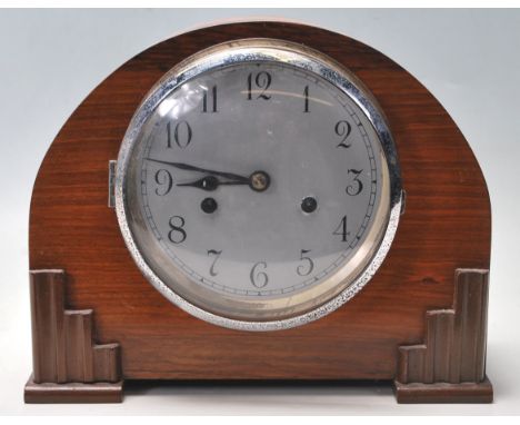 A 1930's Art Deco mahogany cased 8 day mantel clock. The dome mahogany case has a silvered dial and faceted hands with an ins