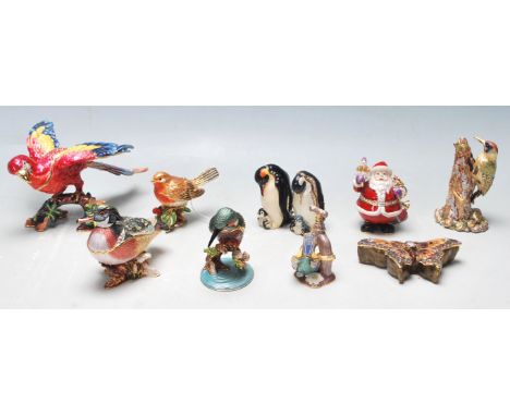 Then vintage 20th century enamelled trinket boxes figurines to include birds, exotic birds, penguins, butterfly, etc. All hav