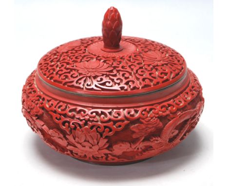 A early 20th century antique Chinese red cinnabar lidded dish / bowl having a hand carved body with dragons and floral design