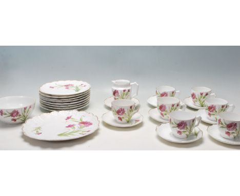 A mid century vintage part tea service having white ground with floral sprays to the side with moulded and gild rims. Unmarke