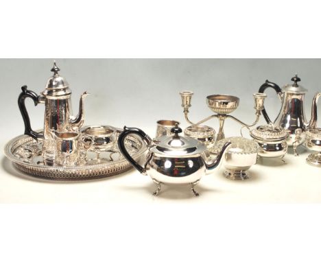 A large quantity of early 20th century silver plate to include trays, coffee pots, candlesticks, creamer jugs, tea light hold