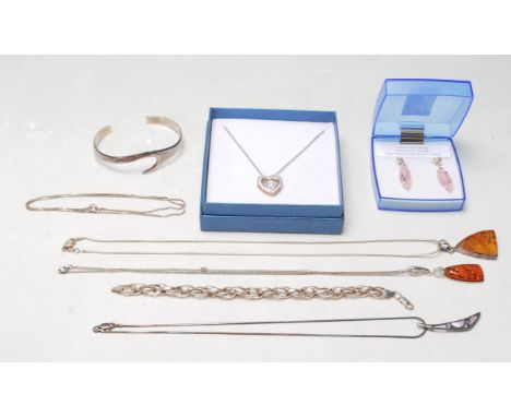 A group of vintage ladies silver jewellery to include an amber pendant on a snake chain, an amber style pendant on a fine lin