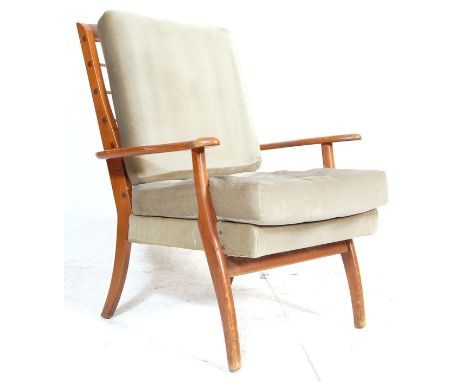 A vintage mid century Parker Knoll easy / lounge armchair. The chair with square tapering legs and shaped elbow rests having 