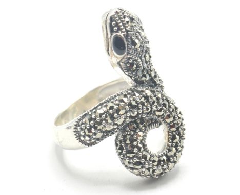 A stamped 925 silver cocktail ring in the form of a coiled snake, being set with marcasites along the scales and having black