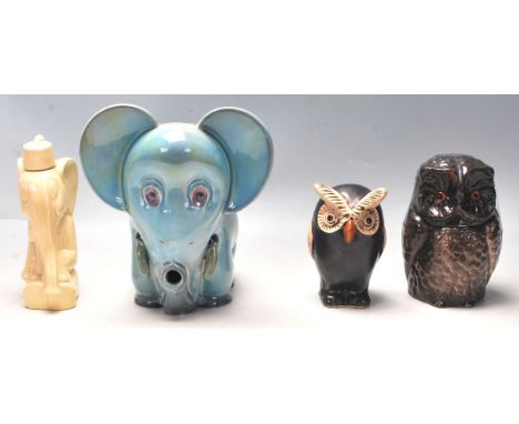 A group of four ceramic studio pottery figurines and tobacco jars the form of two elephants and two owls. The first owl being