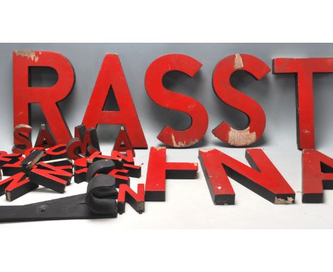 A group of vintage 20th century advertising letters. Seven 25cm tall red and black letters and 25 small &nbsp;8cm letters. Al
