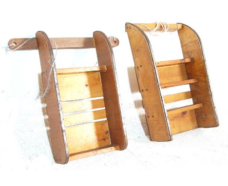 Two vintage mid 20th Century scratch built wooden sleigh's / toboggan both having metal sleighs, slatted construction and rop