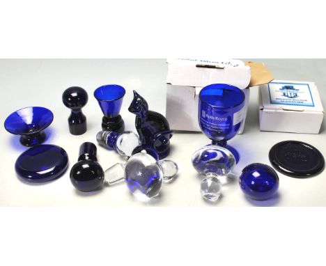 A collection of vintage 20th century Bristol blue art glass to include a ceramic figurine of a cat, small vases, and bottle s