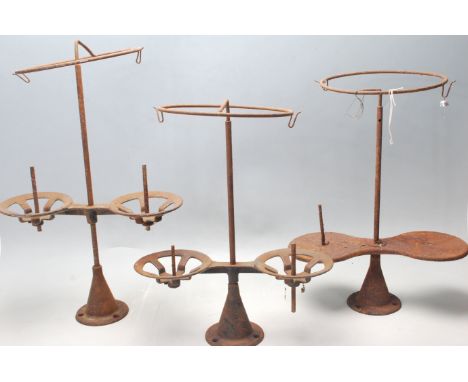 A collection of three 19th Century Victorian glove factory bobbin stands having a circular top over a central support set on 