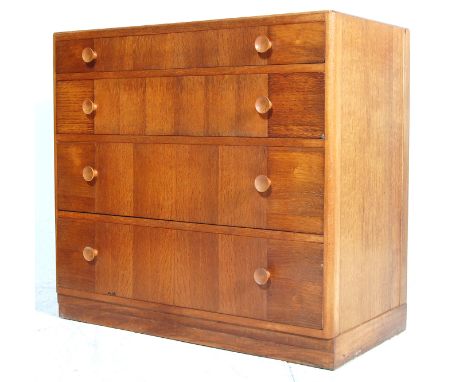 A mid century light oak chest of drawers / secretaire by Kandya. The chest having four graduated drawers with knob handles ra