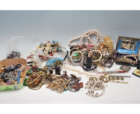 A collection of vintage costume jewellery to include a selection of beaded necklaces, a mother of pearl and coral collar neck