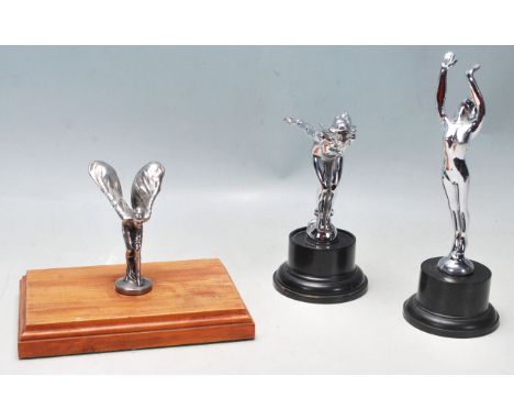 A collection Rolls Royce ' Spirit of Ecstasy ' car emblems - mascots. To include one set on vintage wooden socle plinth, one 