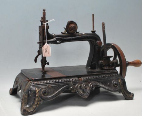 A late 19th century / early 20th century Original Brunonia sewing machine having black enamel paint, cast iron base with foli
