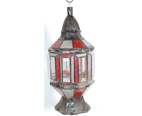 A large 20th century pressed metal and leaded, coloured glass Moroccan - North African lantern. The hanging lantern of octago