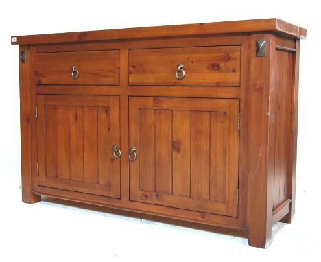 A vintage late 20th century New Zealand Rimu wood sideboard / buffet de corp having a flared top over twin drawers with metal