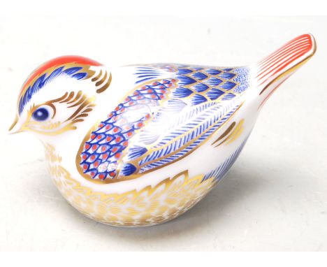 A Royal Crown Derby ceramic Imari paperweight in the shape of a bird decorated in red, blue and gilt having a gold stopper to