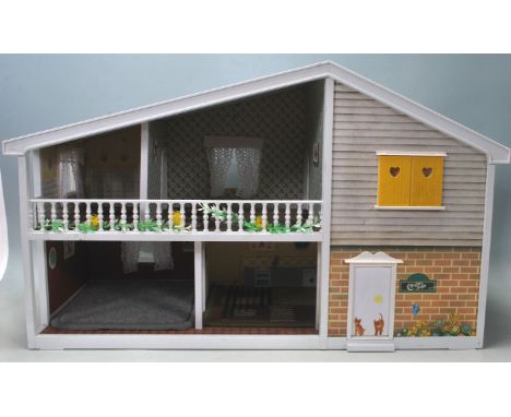 A vintage 20th century dolls house by A. Barton &amp; Co. (Toys) Limited designed by Ray Kyte dolls house having an open fron