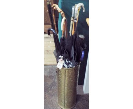 A brass stick stand, various parasols, sticks etc 