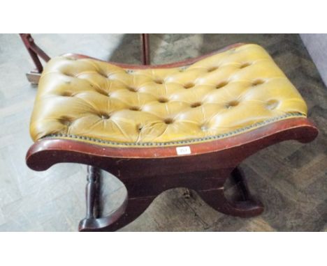 A reproduction mahogany cross framed stool with button leather seat 