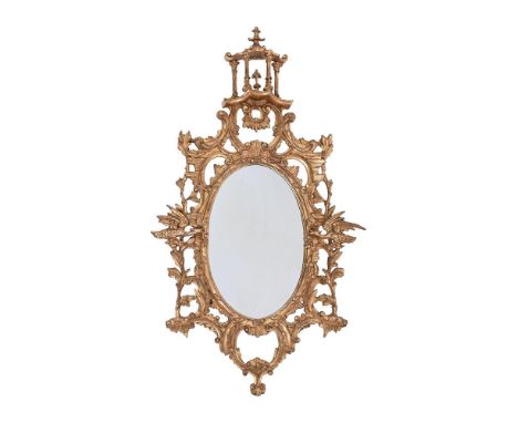 A GILTWOOD OVAL MIRROR IN GEORGE III STYLE  20TH CENTURY, AFTER THE MANNER OF THOMAS CHIPPENDALE 148cm high, 82cm wide  Condi