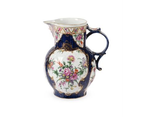 A WORCESTER POLYCHROME PORCELAIN BLUE-SCALE GROUND CABBAGE-LEAF MOULDED MASK JUG   CIRCA 1775 Painted with panels of flower s