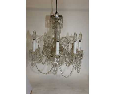 AN EARLY 20TH CENTURY FRENCH EIGHT LIGHT CRYSTAL CHANDELIER with eight shepherds crook arms supporting chains of buttons and 